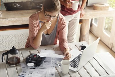 couple-facing-debt-problems-able-pay-out-their-mortgage-thoughtful-woman-looking-frustrated-holding-pen-while-managing-family-budget-making-calculations-using-calculator-notebook-pc